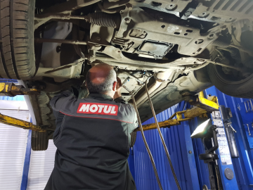 Наш механик готовит автомобиль к замене отработанной жидкости